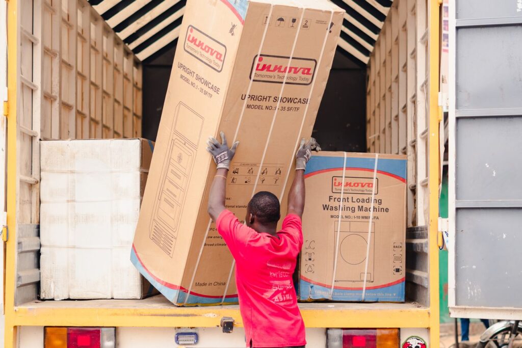 The Art of Drawing Readers In: Your attractive post title goes here A worker in a red shirt loads boxed appliances onto a truck for delivery.