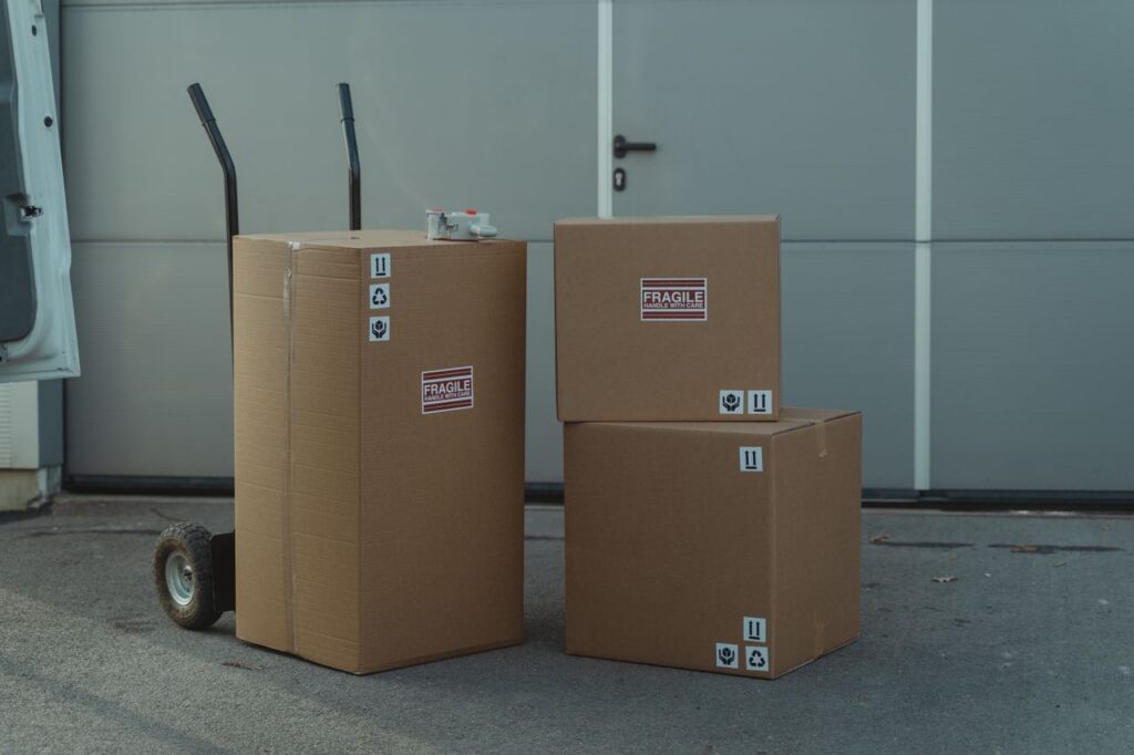 Mastering the First Impression: Your intriguing post title goes here Three cardboard boxes on a dolly, ready for shipping outside a warehouse.